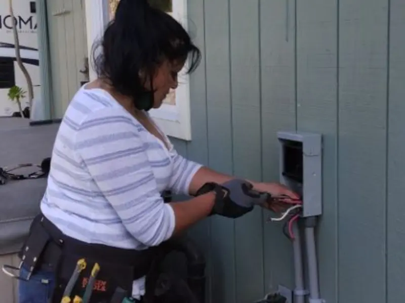 Licensed electrician wiring an exterior subpanel in Wallington